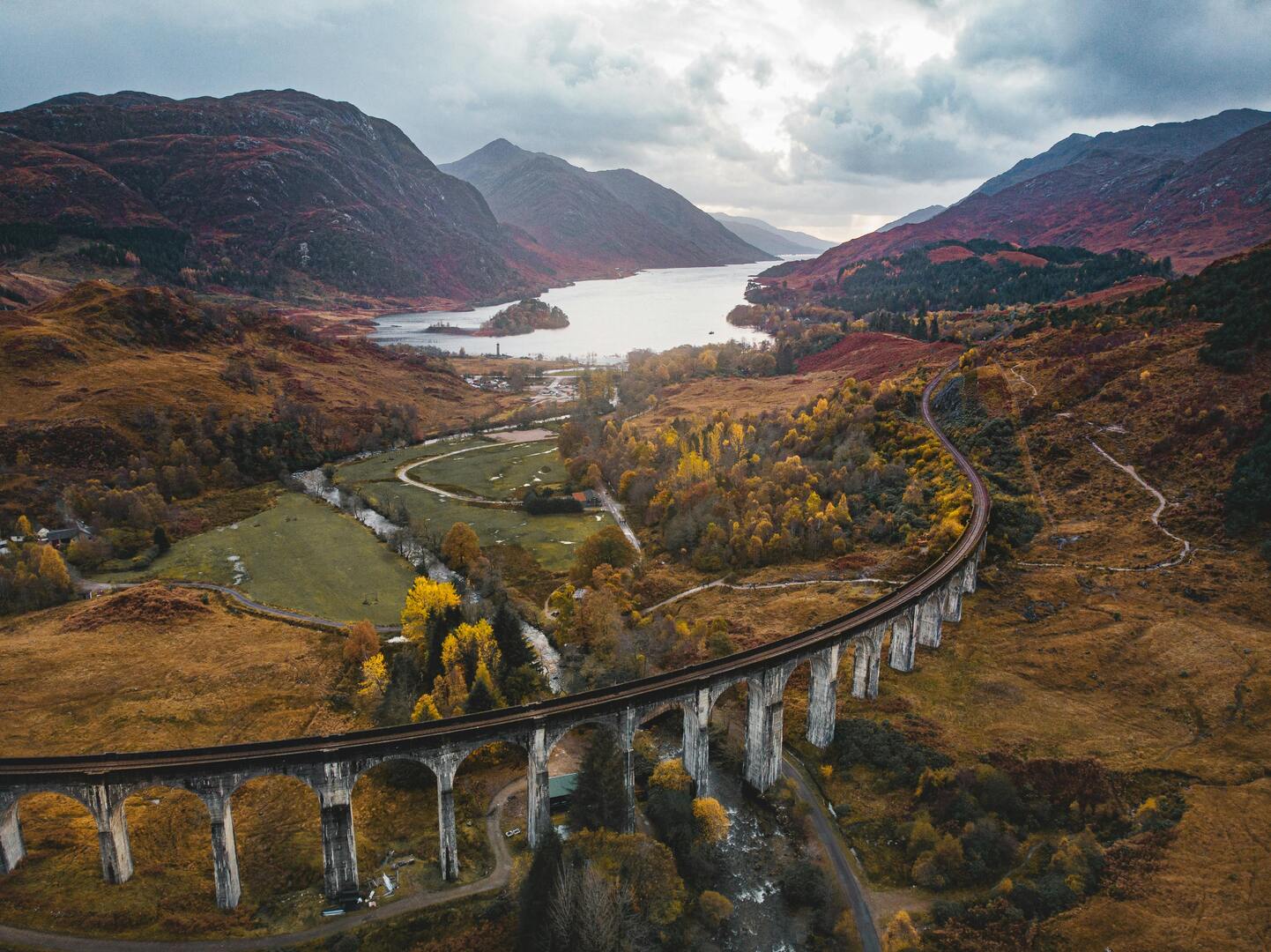 Glenfinnan Viaduct curving above Loch Shiel in the Scottish Highlands